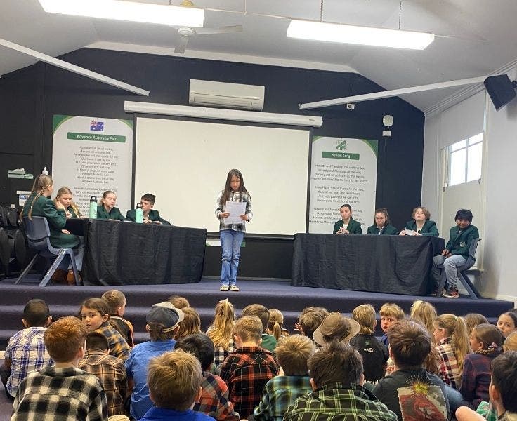 A student addressing everyone before our two debating teams verse one another.