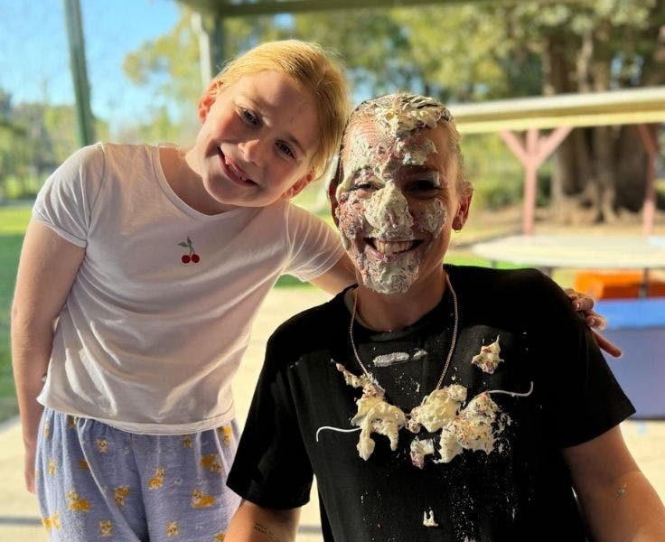 A student standing beside the P&C President after she was pied in the face.